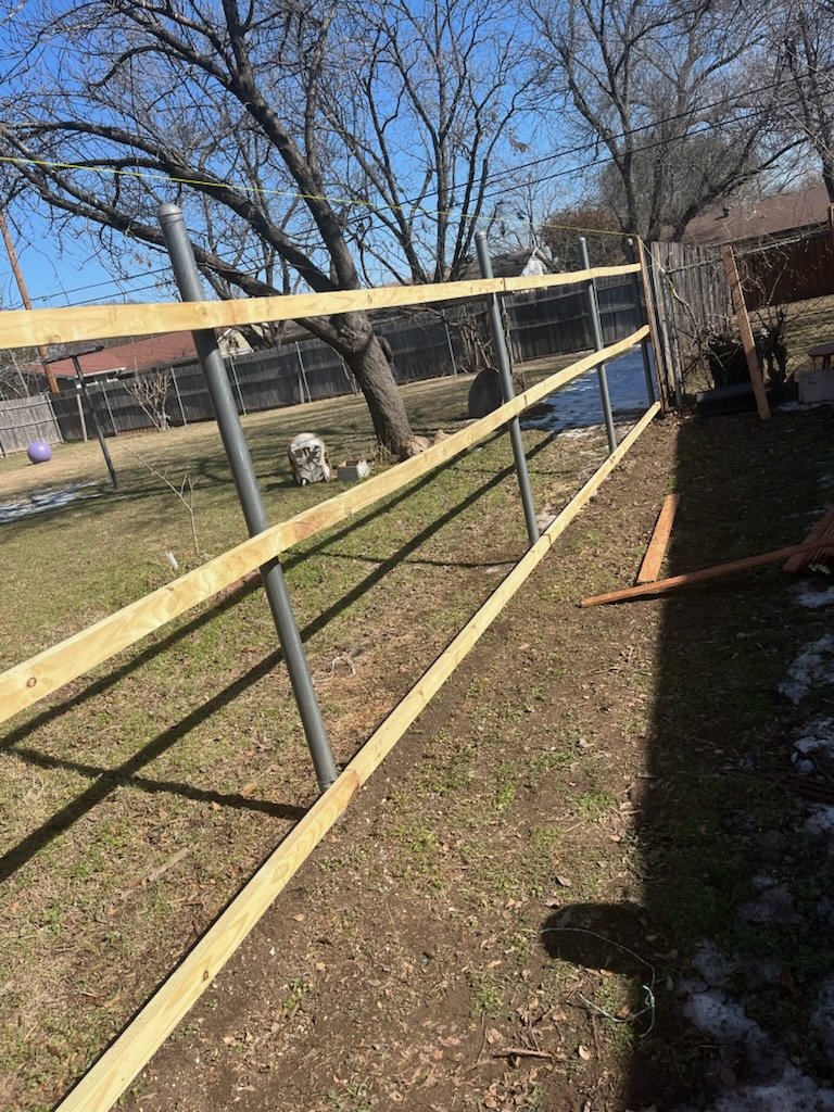 Fence rails attached to metal posts