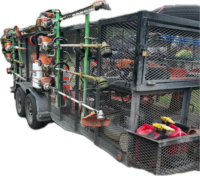Utility trailer carrying landscaping tools